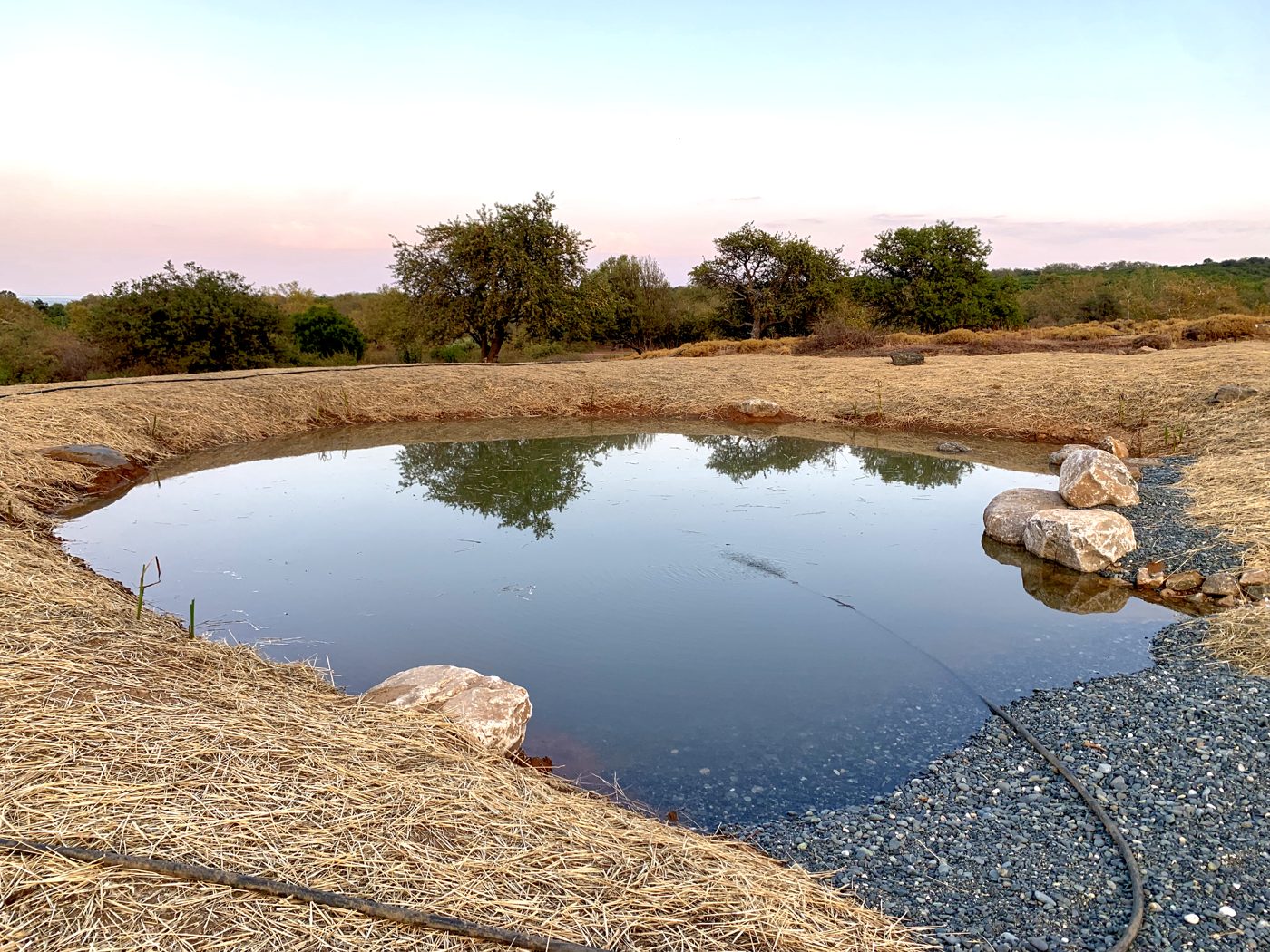 Water retention pond at dusk on a restored landscape
